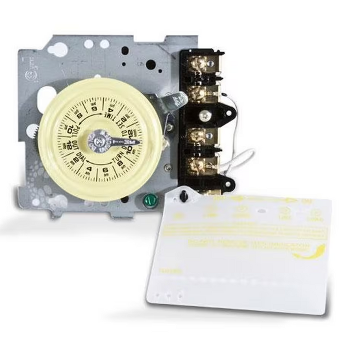 Exposed gears on the Intermatic T104M 24-Hour Mechanical Time Switch (208-277V), showcasing its mechanism-only design, with a separate instruction cover visible in the foreground.