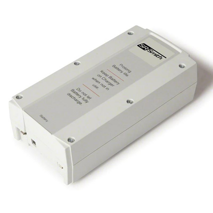 White electronic device with text instructions on top, labeled "S.R. Smith" and "Battery." Screws visible at the corners. Contains an S.R. Smith 100-2000 Linak Battery for Pool Lifts.