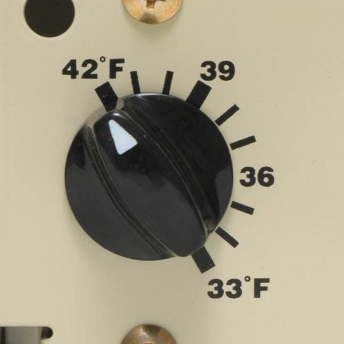 Close-up of the Intermatic PF1103 Freeze Protector dial on a beige panel, set between 36°F and 39°F, with temperature markings from 33°F to 42°F, ensuring precise automatic control.