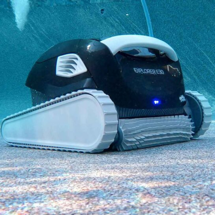 The Maytronics Dolphin Explorer E30 with WiFi Robotic Pool Cleaner 99996241-XPI, featuring tank-like treads, utilizes advanced Dolphin technology to efficiently operate at the bottom of a swimming pool.
