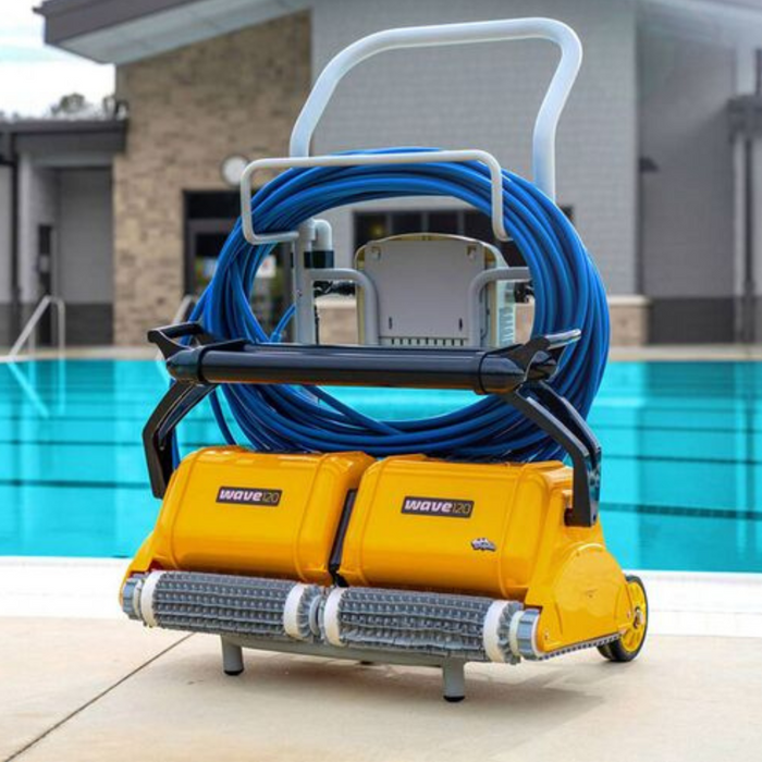 The Maytronics Dolphin Wave 120 Commercial Robotic Pool Cleaner (9999359-W120), a yellow robotic pool cleaner with a blue hose, is labeled "Wave 80" and sits beside a clear blue swimming pool. Perfect for efficient pool maintenance.