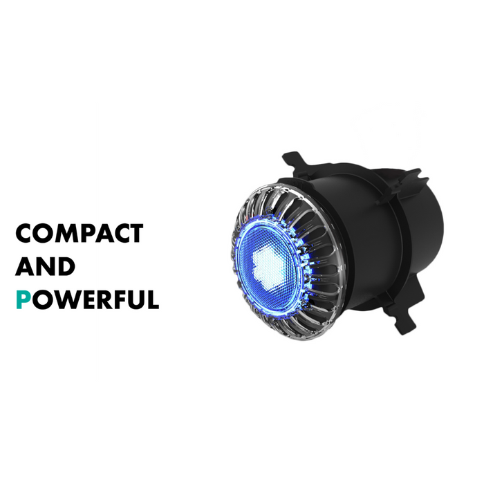 A compact, black electronic device featuring a blue-lit circular core. Text: "COMPACT AND POWERFUL" displayed on the left. The high-intensity Spa Electrics ATOM EM Niche Style 3" LED Pool Light integrates seamlessly with Spa Electrics technology.