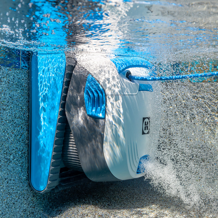 The Hayward R110 Robotic Cleaner for pools up to 33 feet effortlessly glides underwater, scrubbing the pool walls with precision water jets, all while enhancing the ambiance with its serene blue and white design.