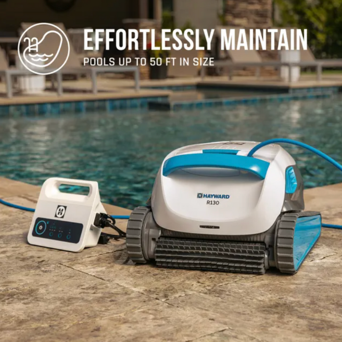Hayward R130 Robotic Cleaner next to a control unit on a stone deck by a pool, promoting effortless maintenance for pools up to 50 ft.