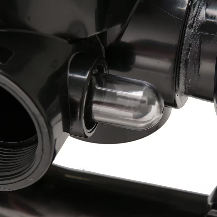 Close-up of a black mechanical device with a transparent cylindrical component and a visible threaded opening, resembling the Hayward SP0715X62 Vari-Flo Side Mount Multiport Valve with 2" ports, used in sand filters by Hayward.